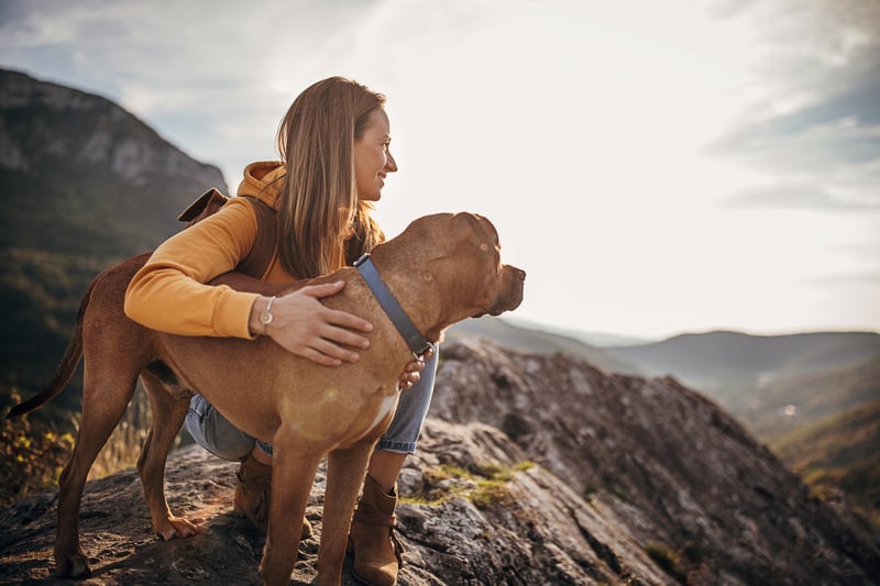 woman hiking with her dog