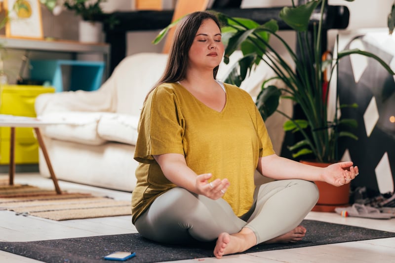 woman meditating on a yoga mat