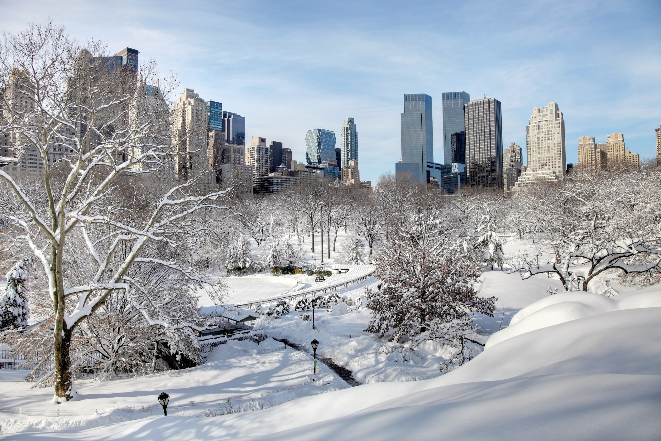 Snowy Central park with Manhattan skyline in the background in NYC, New York.