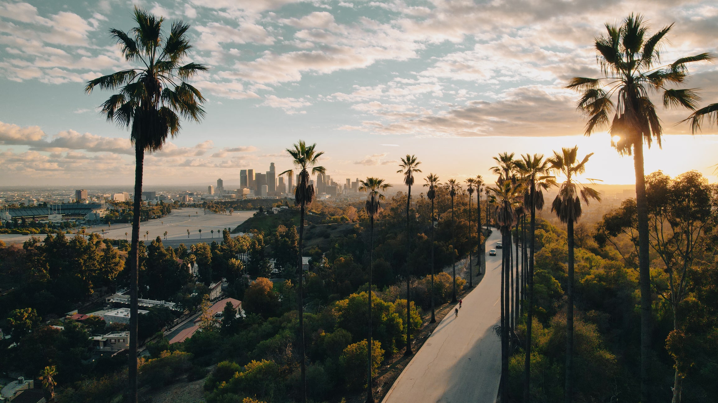 Sunset on palm tree-lined street in LA, California.